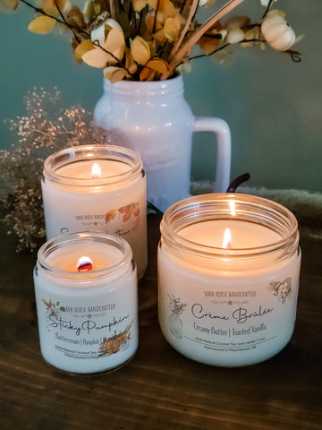 Collection of 3 fall scented candles, different sizes.